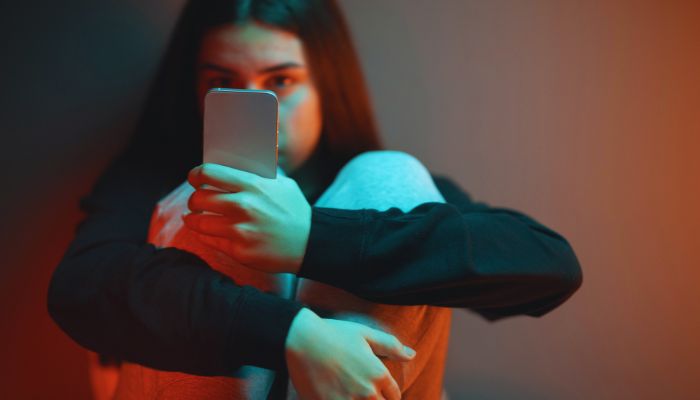 girl looking at the phone and depressed 