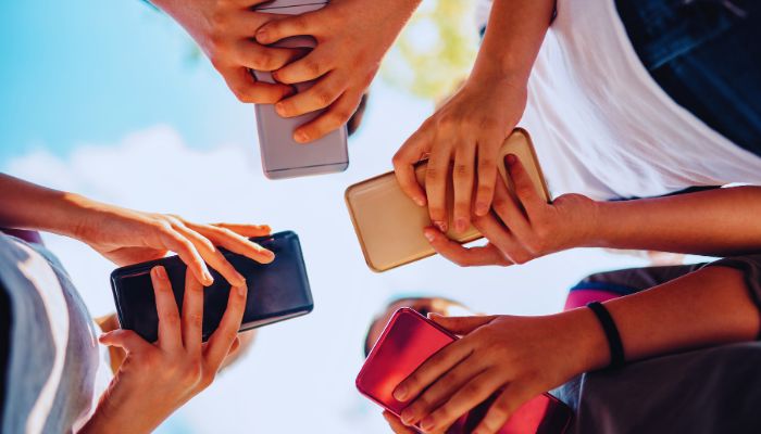 group of kid changing info with smart phone